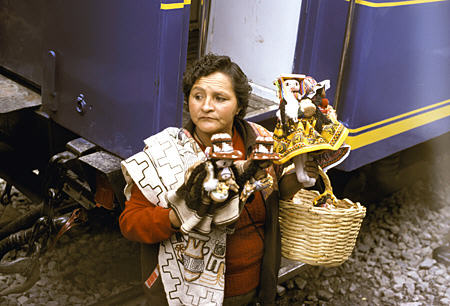 Woman selling souvenirs at Ollantaytambo during train trip to Machu Picchu. Peru.