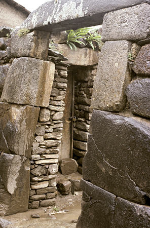 Incan gate used as entrance to present day house in Ollantaytambo. Peru.