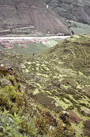 View of Pisac Village in Sacred Valley & Urubamba River from Incan Fortress. Peru.