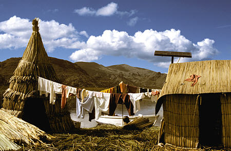Reed hut with laundry & solar panel on Uros Floating Islands, Lake Titicaca. Peru.