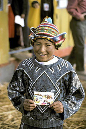 Schoolboy with his drawing on Uros Floating Islands, Lake Titicaca. Peru.