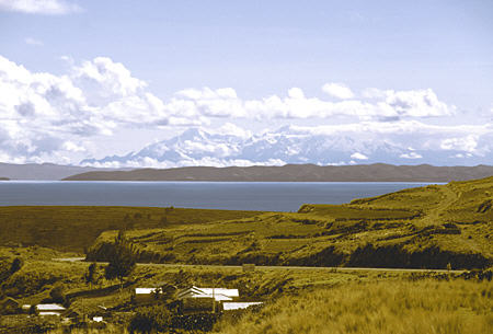 Snow capped mountains in Bolivia seen across Lake Titicaca. Peru.
