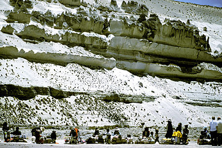 Stratified rock formation & native souvenir sellers in Cañahuas. Peru.