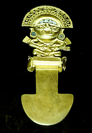 Lambayeque tumi with seated high official made of gold with turquoise in Gold Museum, Lima. Peru.
