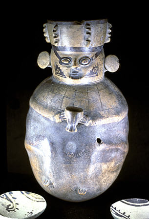 Chancay figure holding cup (13-15thC) in Lima's Gold Museum. Peru.