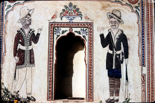 Painting on wall of haveli (manor house) shows two Indians with antique rifles. Mandawa, India.