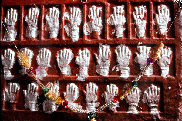 Relief of hands where women once touched the wall before throwing themselves on husband's funeral pyres (Sati) in Jodhpur Palace. India.