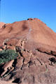 Hikers make climb up Uluru even though aboriginals ask them not to because the mountain is sacred. Australia.