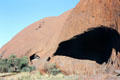 Massive cave opening on side of Uluru. Australia.