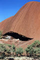 Overhanging mouth of a cave at base of Uluru. Australia.
