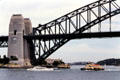 Ferries make their way under Sydney Harbour Bridge. Sydney, Australia.