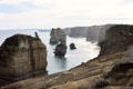 Twelve Apostles rock formations rise out of water in Port Campbell National Park. Australia.