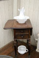 Simple wash basin & pitcher, commode & wooden stand at Van Gogh House in Cuesmes. Mons, Belgium.