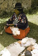 Woman spinning Alpaca thread on Sun Island. Bolivia.