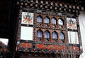Symbolic murals frame a window on house in Paro. Bhutan.
