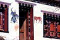 Symbolic murals protect a doorway on a house in Paro. Bhutan.