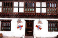 Ribboned male symbols invite prosperity to house in Paro. Bhutan.