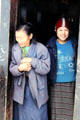 Two women in doorway on road to Punaka from Thimpu. Bhutan.