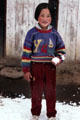 Child playing with snow on road to Punaka from Thimpu. Bhutan
