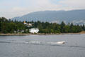 Seaplane landing seen against Stanley Park. Vancouver, BC.