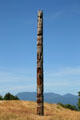 Totem pole at Museum of Anthropology at UBC against surrounding mountains. Vancouver, BC.