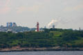 Lighthouse at entrance to Saint John Harbor with city beyond. Saint John, NB.