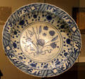 Fritware dish with underglaze painting of flowers from Iran at Aga Khan Museum. Toronto, ON.