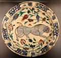 Fritware dish painted with lion & flowers from Iznik, Turkey at Aga Khan Museum. Toronto, ON.