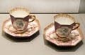 Meissen porcelain coffee cups & saucers decorated with European scenes in white quatrefoils at Gardiner Museum. Toronto, ON.