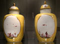 Meissen porcelain covered vases decorated in yellow with imaginary Chinese scenes in white quatrefoils at Gardiner Museum. Toronto, ON.