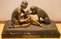 Art Deco polychromed bronze sculpture accident during the hunt with woman bandaging dog from Boise, France at Royal Ontario Museum. Toronto, ON.