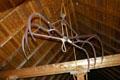 Hay bail lifer hangs from rafters of barn at Green Gables. Cavendish, PE.
