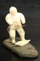 Inuit carved ivory & steatite hunter pulling seal from ice breathing hole at Montreal Museum of Fine Arts. Montreal, QC