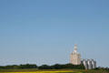 Grain elevator over canola crop on Saskatchewan prairie. SK.