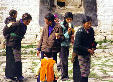 Worshippers at the Sera Monastery holding yak oil lamps in Tibet. China.
