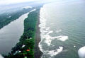 Coast seen from air on plane to Tortuguero National Park with airstrip on tip of barrier island. Costa Rica.