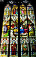 Stained glass windows showing the Cathedral's name saints Peter & Mary over row of four Doctors of the church. Köln, Germany.