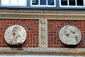 Medallions on brick façade of Hube-Haus. Hamburg, Germany