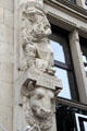 Versmann-Haus carvings of aproned man holding pigs on City Hall Market square. Hamburg, Germany