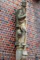 Sculpture of chimney sweep on brick building at Steinstraße & Mohlenhofstraße. Hamburg, Germany.