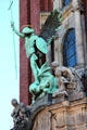 St Michael's Victory over the Devil sculpture above the main entrance to St Michael's Church. Hamburg, Germany.
