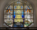 Stained glass window with the light of Holy Spirit shining on Hamburg between two angels. Hamburg, Germany