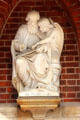 Statue of Evangelist, St. Matthew, with his attribute angel at entrance to St. Peter's Church. Hamburg, Germany.