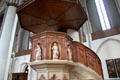 Carved wooden pulpit with marble statues of the Evangelists in St. Peter's Church. Hamburg, Germany.