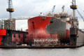 Ship in floating drydock at Elbe River shipyard. Hamburg, Germany.