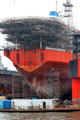 Ship with scaffolding in drydock at Elbe River shipyard. Hamburg, Germany.