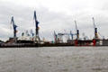 Drydock & cranes as seen from Elbe River. Hamburg, Germany.
