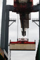 Crane carrying container at container port. Hamburg, Germany.