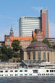 Red tower of Atlantic-Haus above Brown dome of Alter Elbtunnel at St. Pauli Pier. Hamburg, Germany.