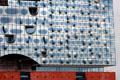 Glass facade of Elbphilharmonie concert hall on Grasbrook Peninsula of Elbe River in HafenCity. Hamburg, Germany.